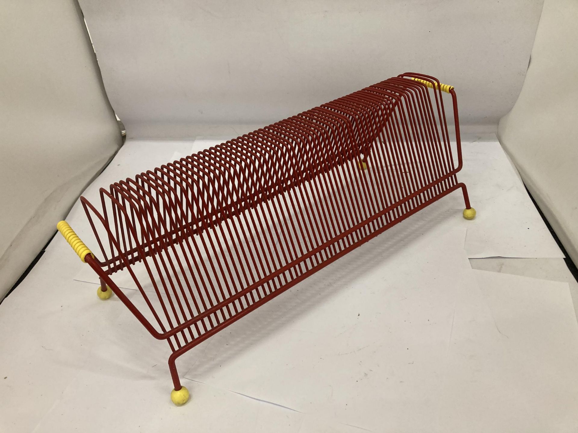 A RETRO RED TUBULAR RECORD RACK