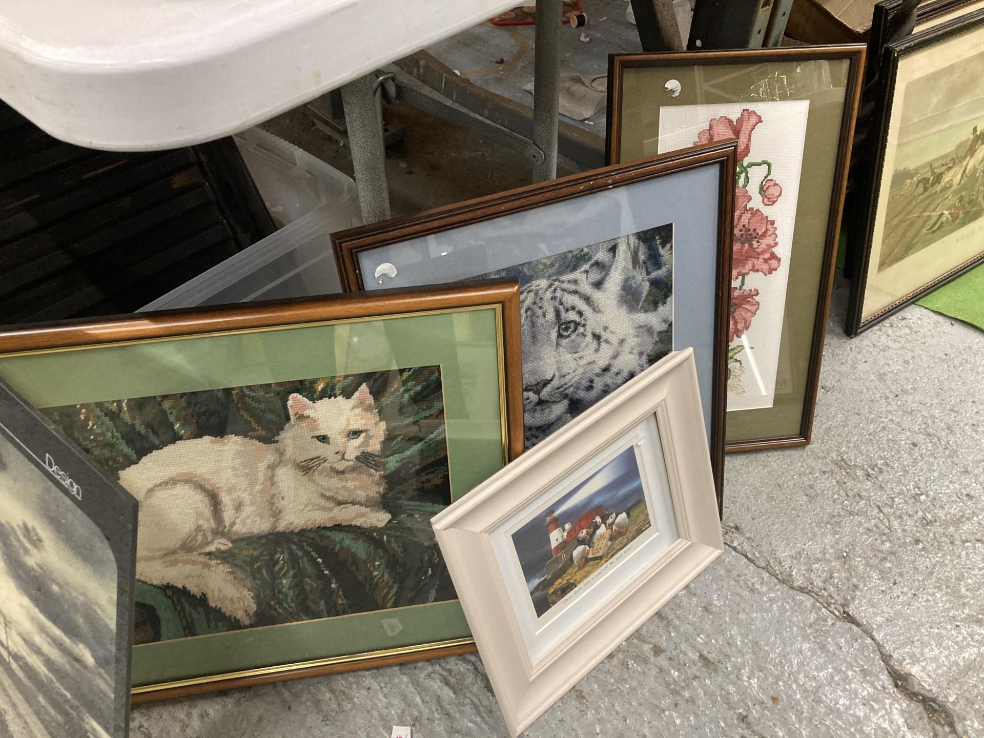 THREE FRAMED TAPESTRIES, A CAT, TIGER AND FLOWERS PLUS A HUMOROUS PRINT OF PUFFINS