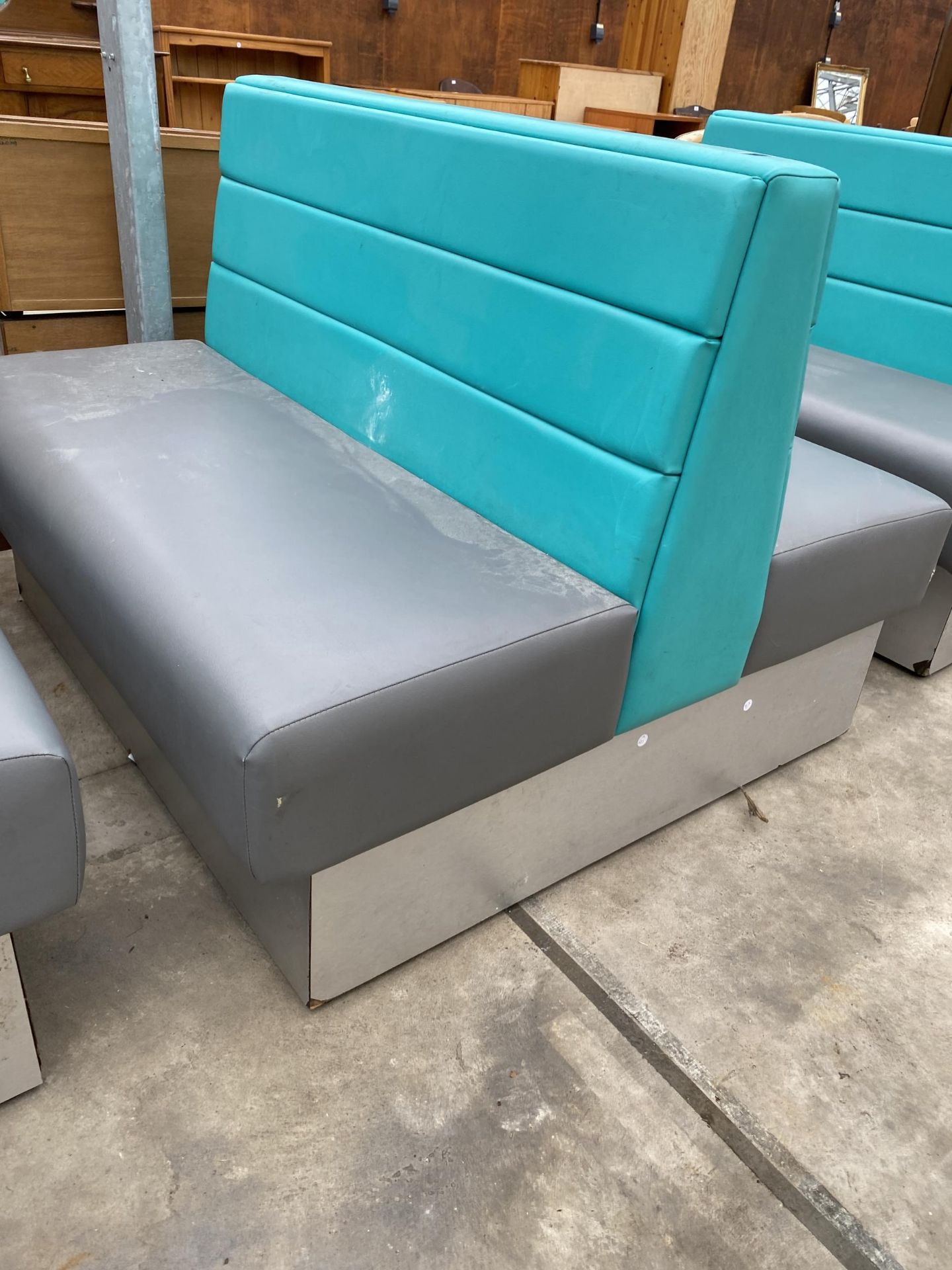 A MODERN DOUBLE SIDED BOOTH SEATING IN TURQUOISE AND GREY