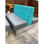 A MODERN DOUBLE SIDED BOOTH SEATING IN TURQUOISE AND GREY
