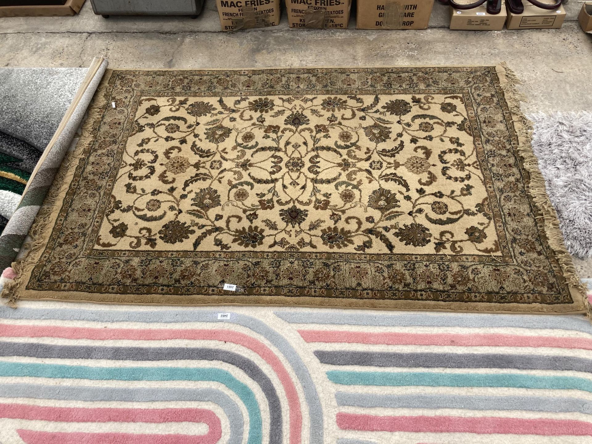 A BROWN PATTERNED FRINGED RUG