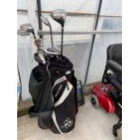 A WILSON STAFF GOLF BAG WITH AN ASSORTMENT OF GOLF CLUBS TO INCLUDE PING ETC