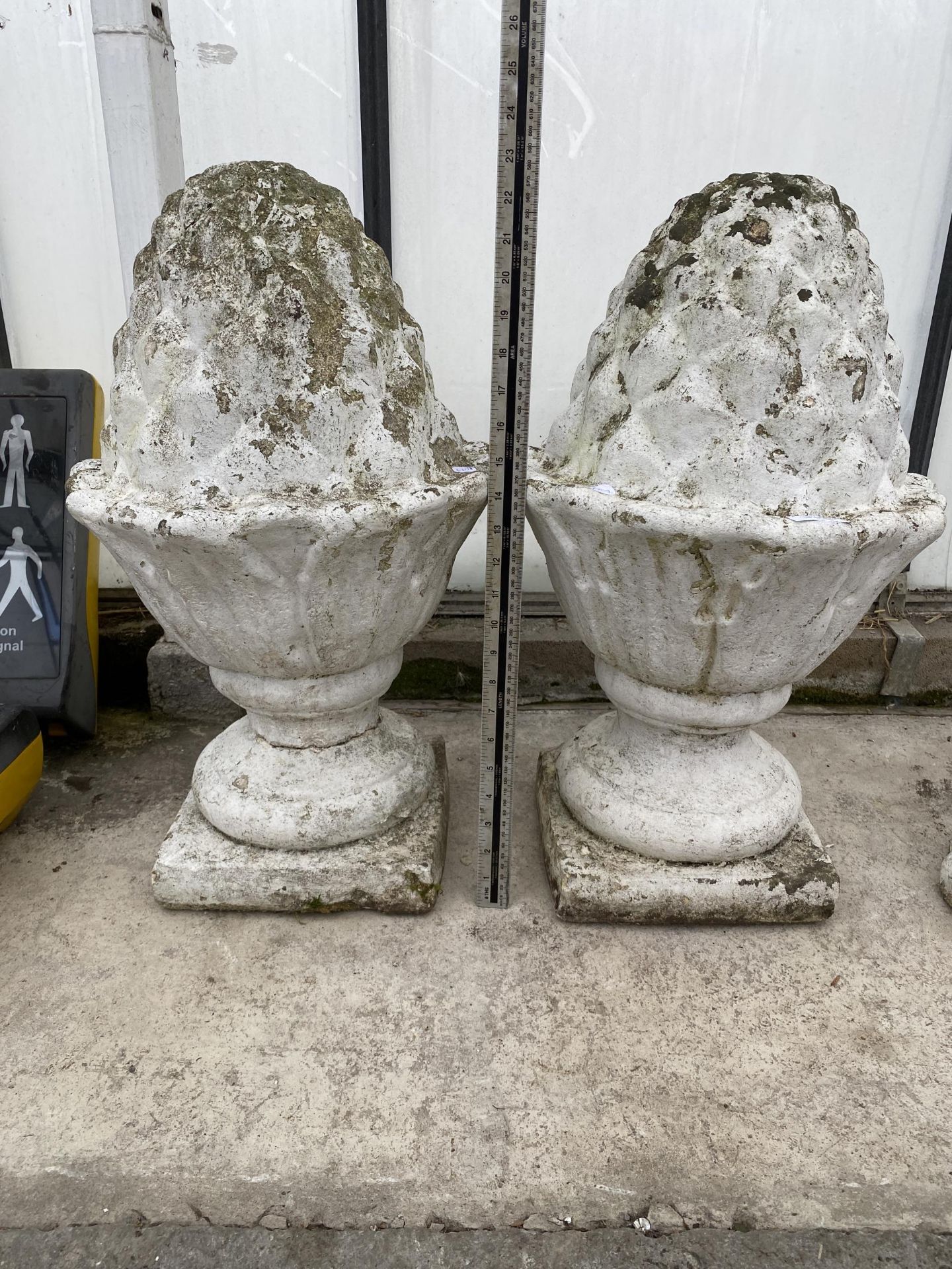 A PAIR OF WHITE PAINTED RECONSTITUTED STONE ACORN FINIALS