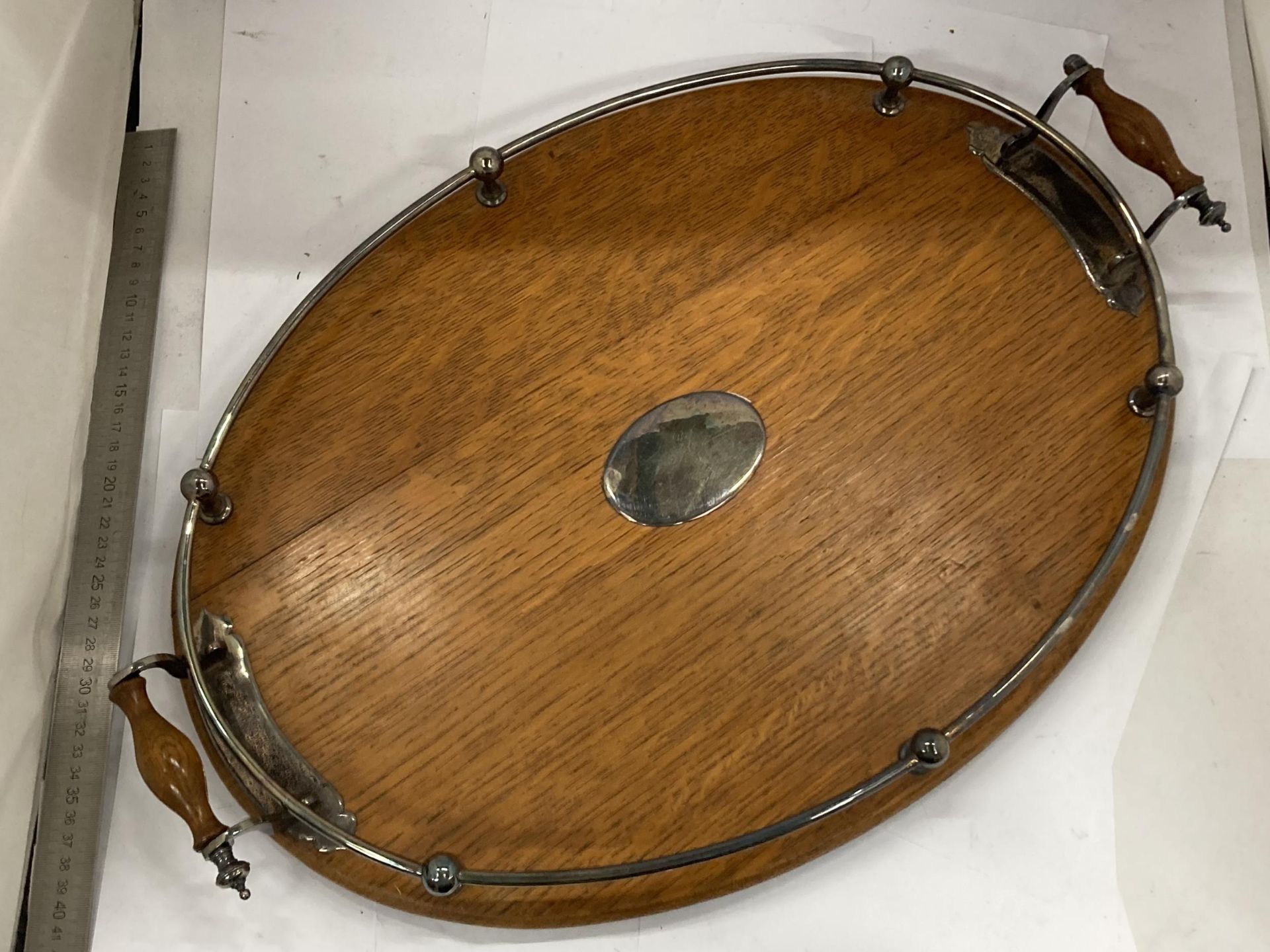 A VINTAGE OAK AND TWIN HANDLED DRINKS TRAY WITH SILVER PLATED GALLERY AND MOUNTS