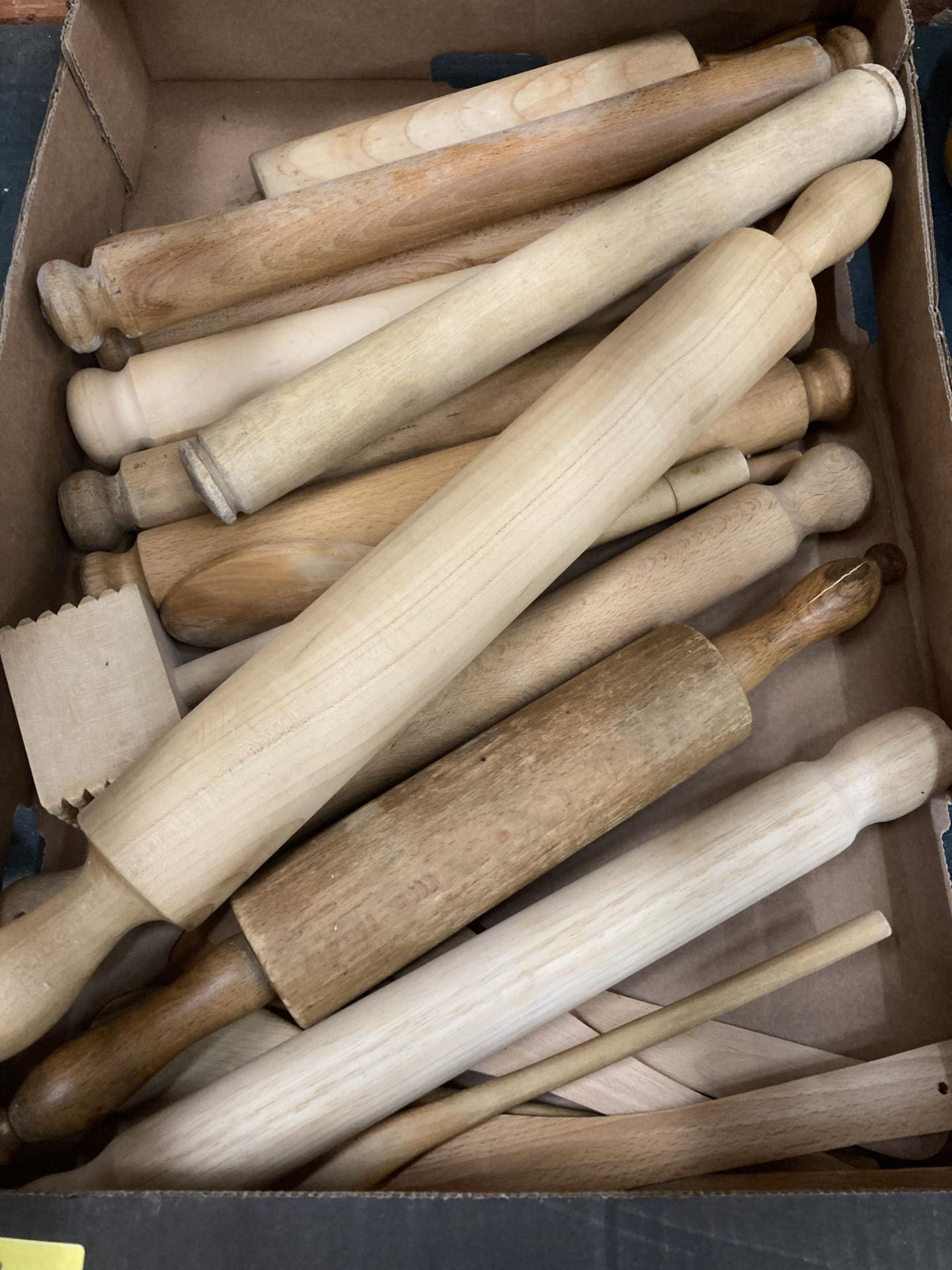 A BOX OF WOODEN ROLLING PINS