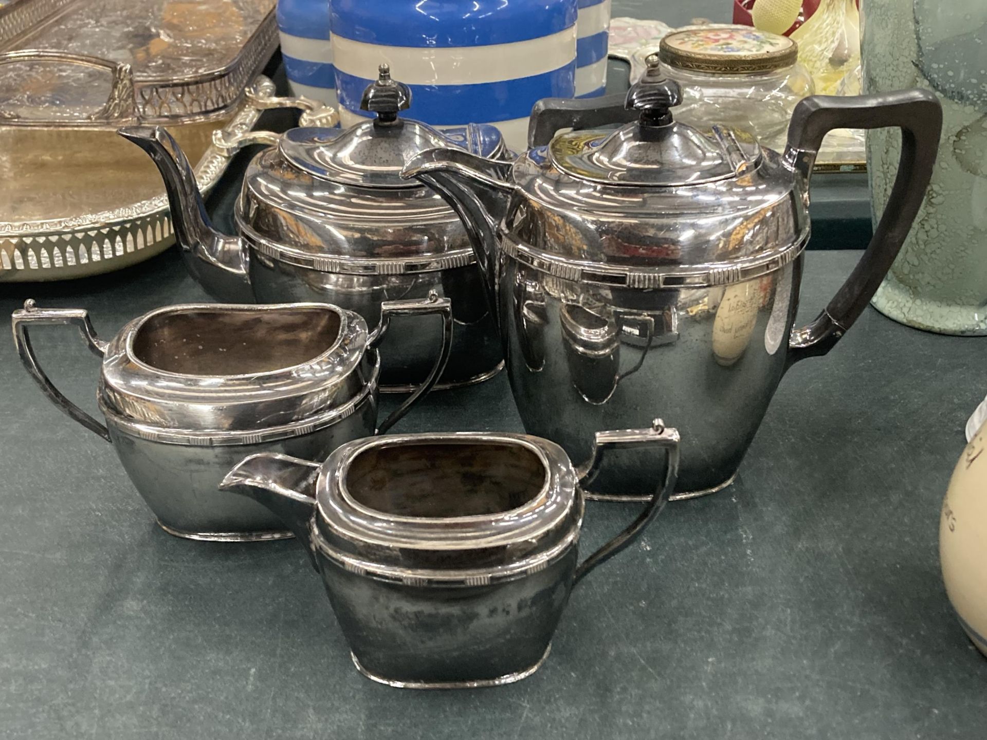 A VINTAGE FOUR PIECE SILVER PLATED TEA SET