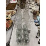 A COLLECTION OF GLASSWARE TO INCLUDE CUT GLASS DECANTERS, SILVER PLATED CLARET JUGS ETC