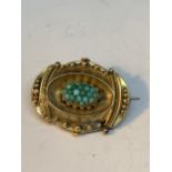 A TESTED TO 9 CARAT GOLD BROOCH LOCKET WITH TURQUOISE STONES GROSS WEIGHT 9.69 GRAMS