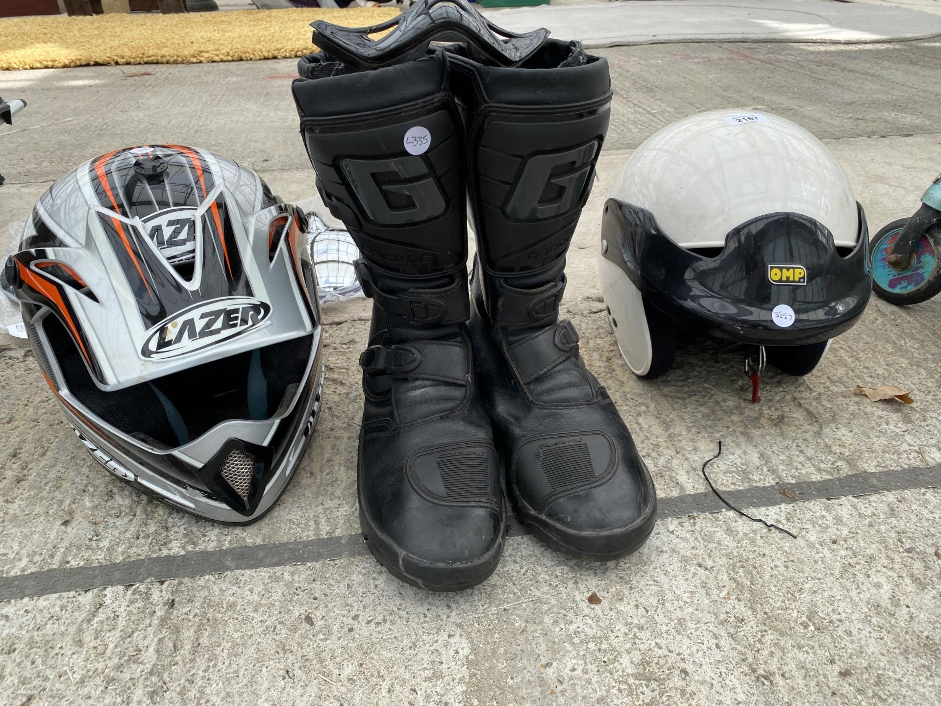 TWO MOTORBIKE HELMETS AND A PAIR OF BOOTS