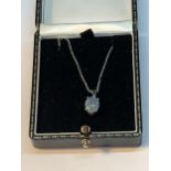 A SILVER NECKLACE WITH A PALE BLUE OPAL STYLE PENDANT IN A PRESENTATION BOX