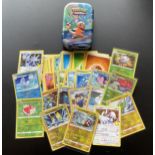 A TIN OF ASSORTED POKEMON CARDS, HOLOS ETC