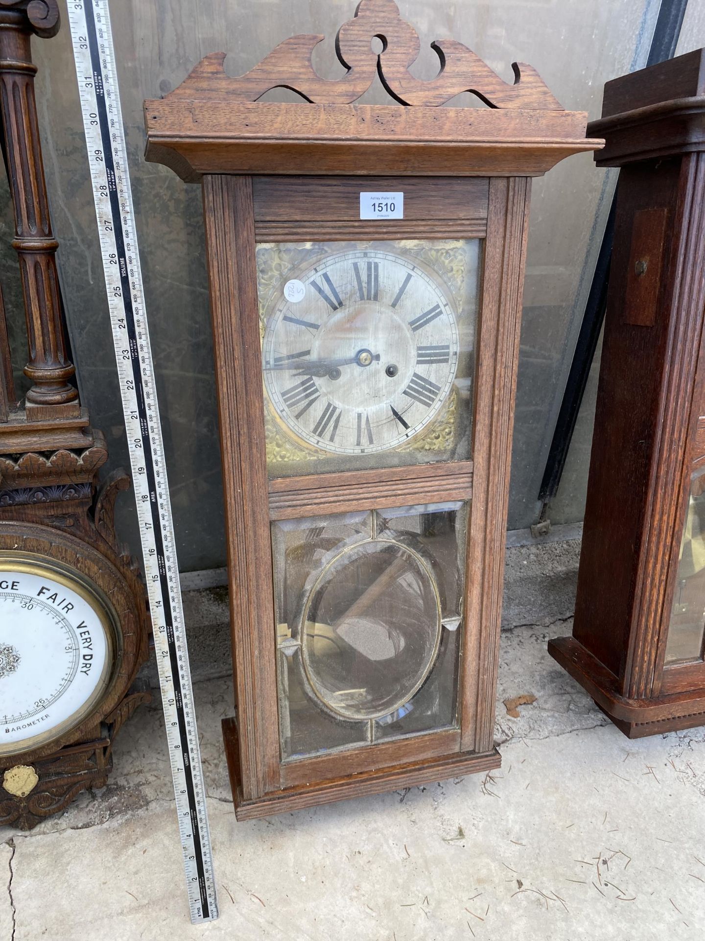 A VINTAGE OAK CASED CHIMING WALL CLOCK