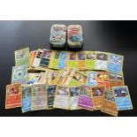 TWO TINS OF ASSORTED POKEMON CARDS, HOLOS ETC