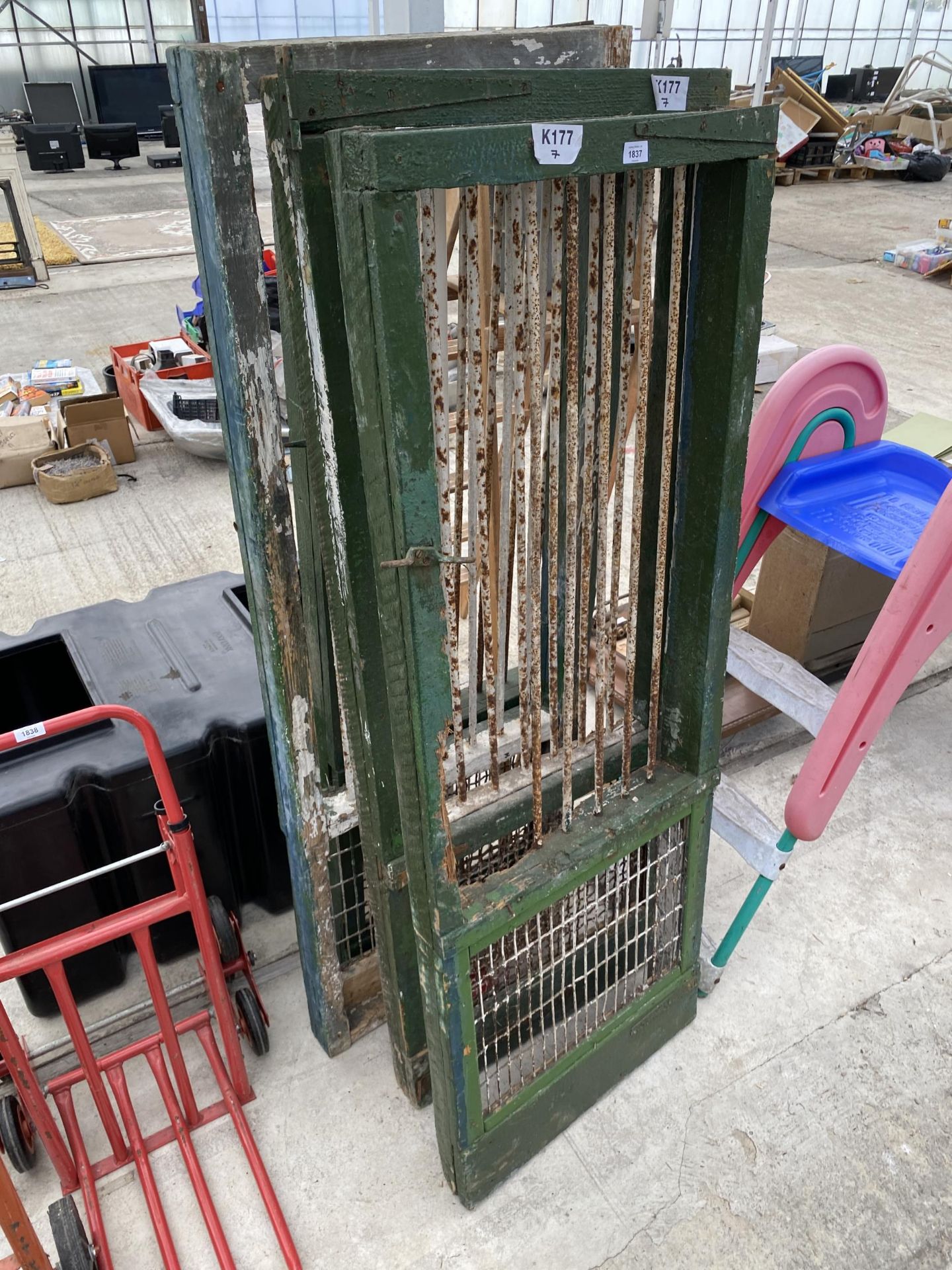 FOUR VINTAGE WOODEN DOORS WITH MESH BOTTOM SECTION AND STEEL BARS TO THE TOP SECTION