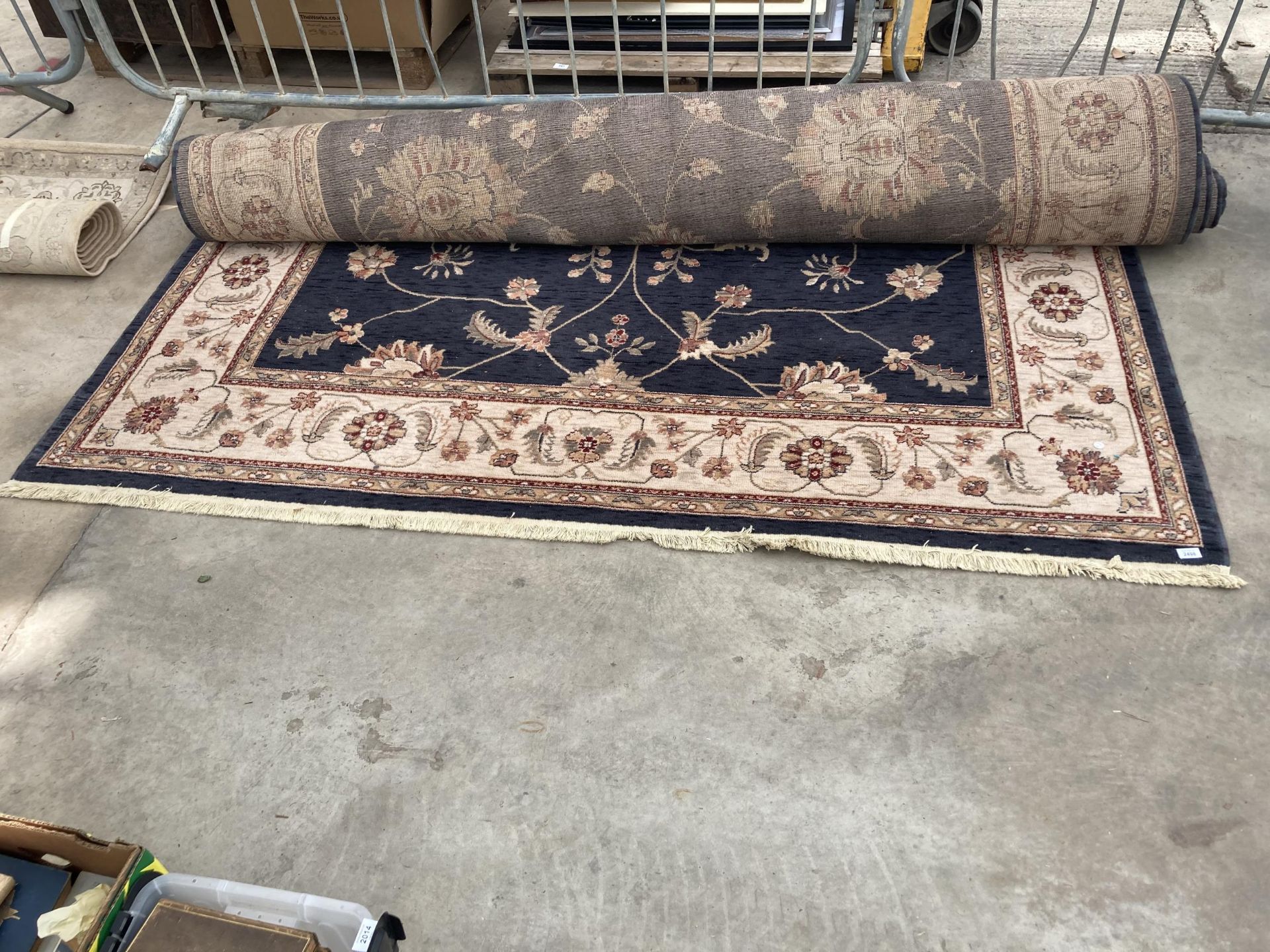 A LARGE BLACK AND CREAM PATTERNED RUG