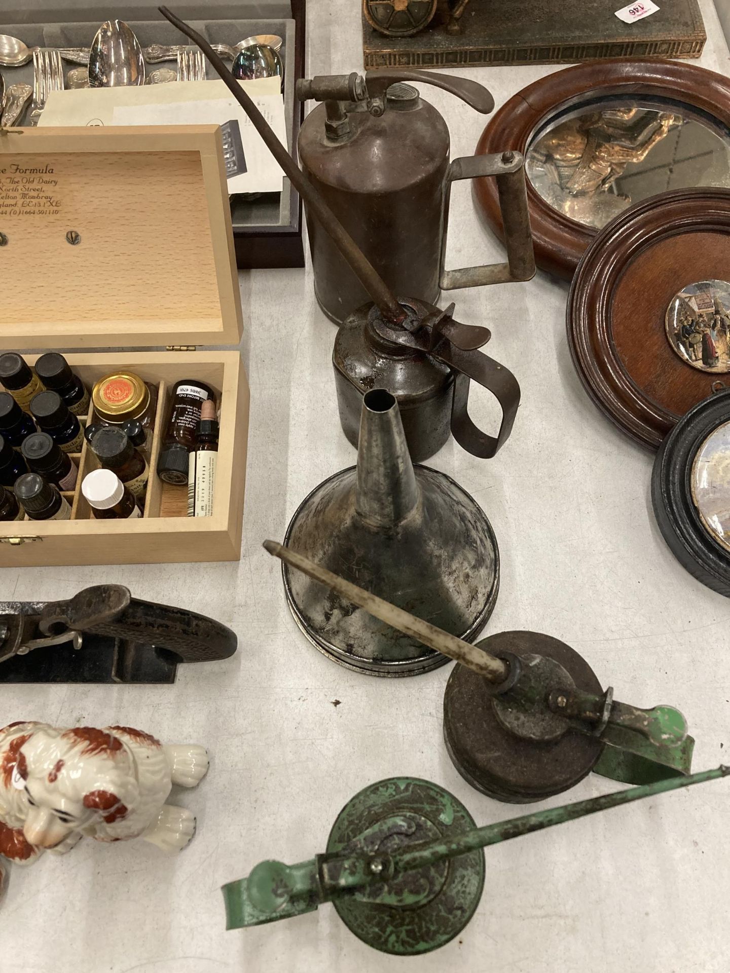 FOUR VINTAGE OIL CANS PLUS A FUNNEL