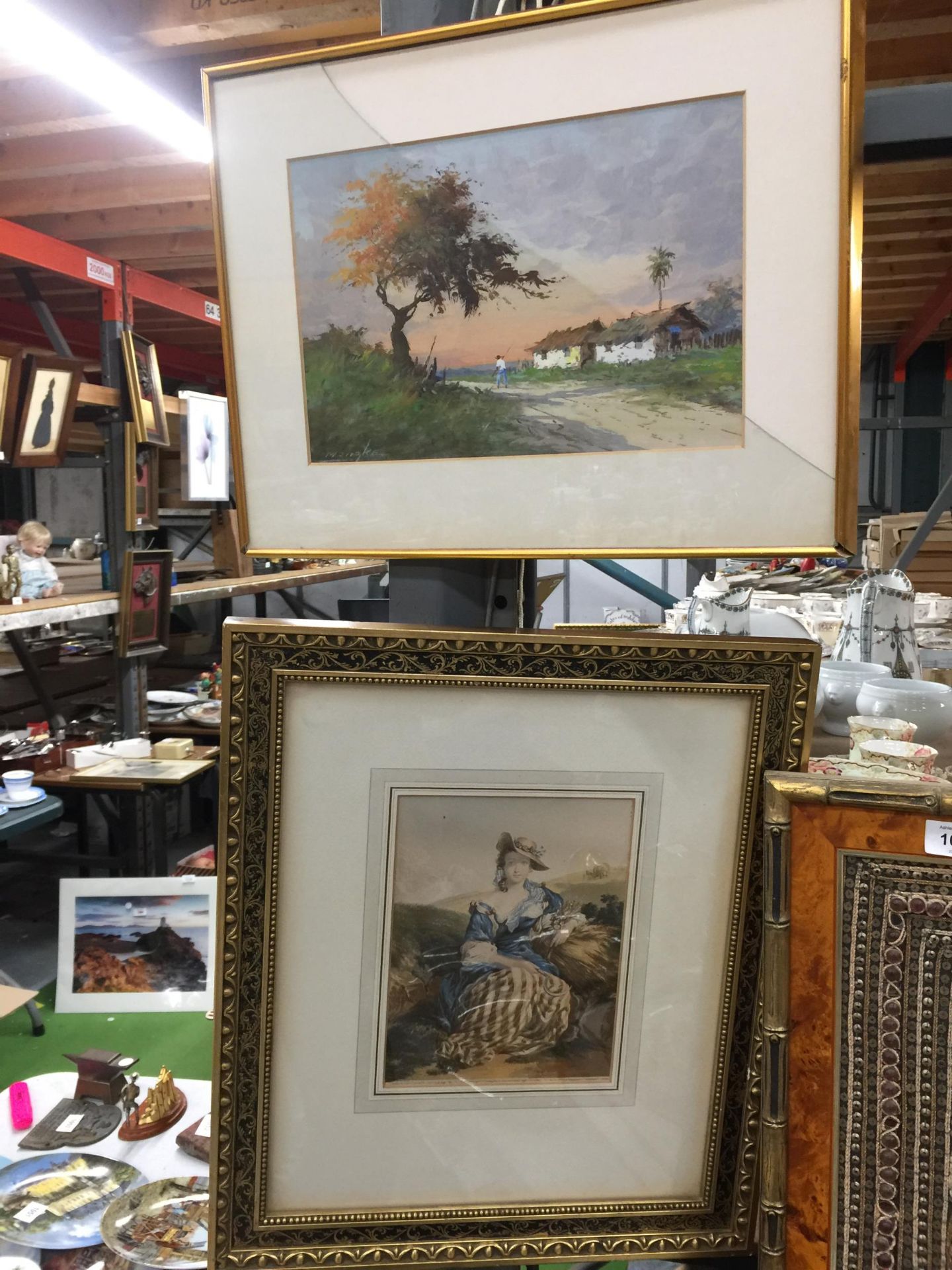 A FRAMED WATERCOLOUR, SIGNED- GLASS A/F, PLUS A GILT FRAMED PRINT OF A LADY IN THE HAY FIELD