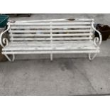 A THREE SEATER WOODEN SLATTED GARDEN BENCH WITH SCROLL METAL ENDS AND MIDDLE SUPPORT