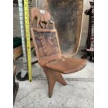 A SMALL TRIBAL CARVED FOLDING WOODEN SPINNING SEAT