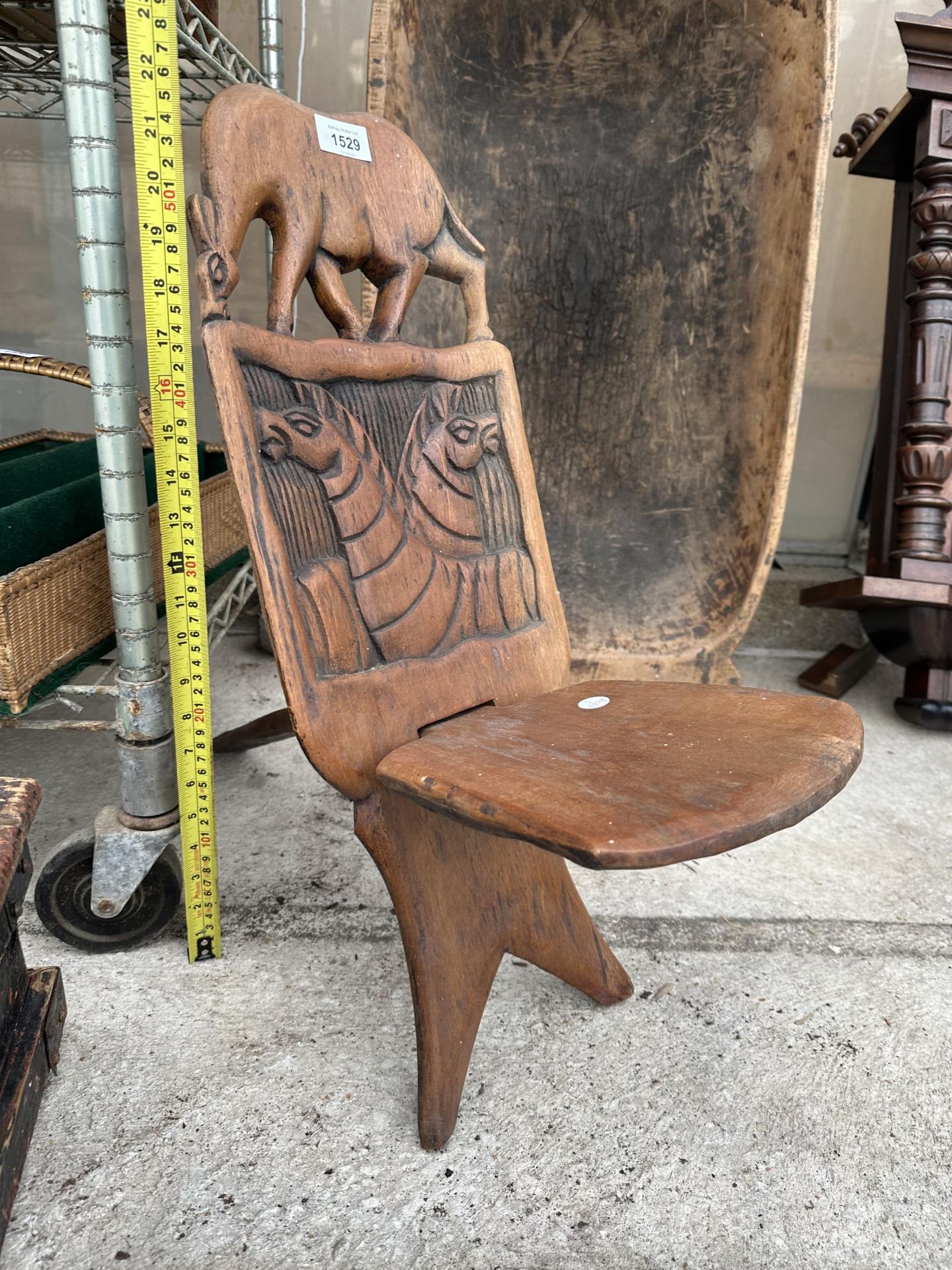 A SMALL TRIBAL CARVED FOLDING WOODEN SPINNING SEAT