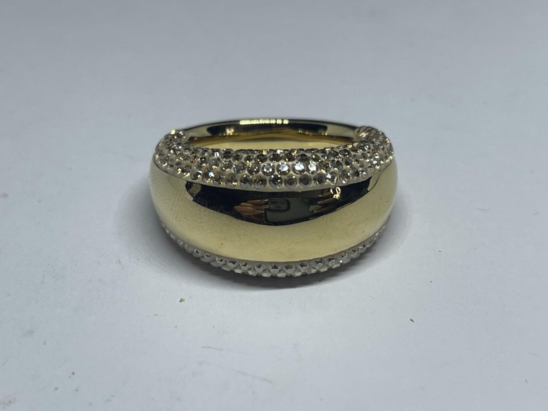 A SWAROVSKI CRYSTAL RING WITH LABEL IN A PRESENTATION BOX AND SLEEVE SIZE R/Q