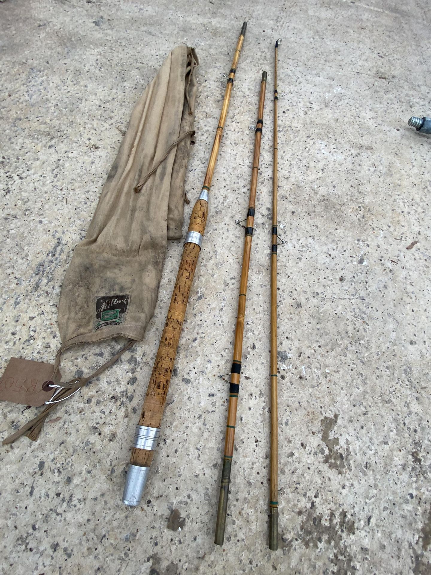 A VINTAGE SPLIT CANE FISHING ROD WITH A MILBRO ROD BAG