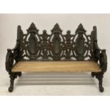 A TABLE TOP CAST VICTORIAN STYLE BENCH WITH WOODEN SLATTED SEAT
