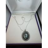 A SILVER NECKLACE WITH A LARGE BLUE STONE PENDANT IN A PRESENTATION BOX