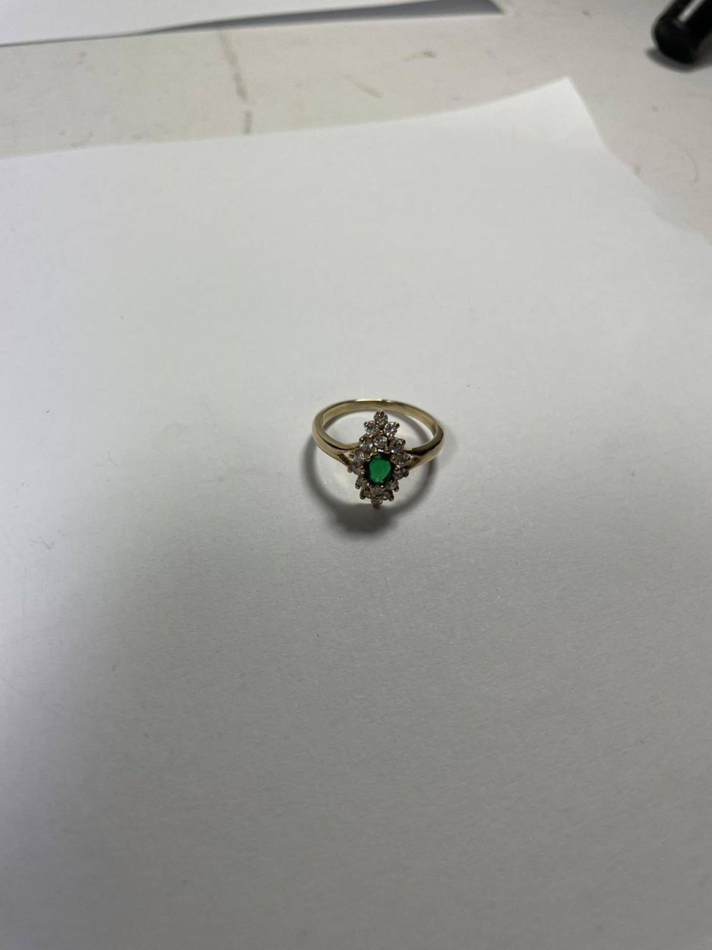 A 9 CARAT GOLD RING WITH CENTRE GREEN STONE SURROUNDED BY CUBIC ZIRCONIAS IN A DIAMOND SHAPE SIZE - Image 3 of 3