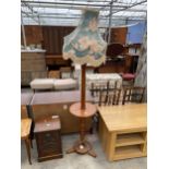 A MID 20TH CENTURY MAHOGANY STANDARD LAMP WITH MID HEIGHT SHELF COMPLETE SHADE