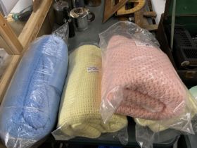 FOUR VINTAGE HONEYCOMB BLANKETS, TWO YELLOW, ONE PINK AND ONE BLUE