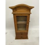 AN APPRENTICE PIECE CABINET WITH TWO DRAWERS AND A MESH FRONTED DOOR