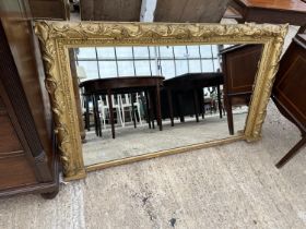 A VICTORIAN GILT FRAMED OVERMANTLE MIRROR WITH GOLD FOLIATE DECORATION, 55 X 33" BEARING PAPER