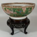 A LARGE 19TH CENTURY CHINESE FAMILLE VERTE PORCELAIN DRAGON DESIGN BOWL ON CARVED WOODEN STAND,