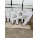 AN ASSORTMENT OF PLASTIC SIGN LETTERS AND NUMBERS WITH STANDS