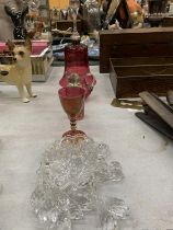 A QUANTITY OF CRANBERRY GLASS TO INCLUDE A LARGE BELL, JUG, SCENT BOTTLE, GLASS AND CANDLE HOLDERS