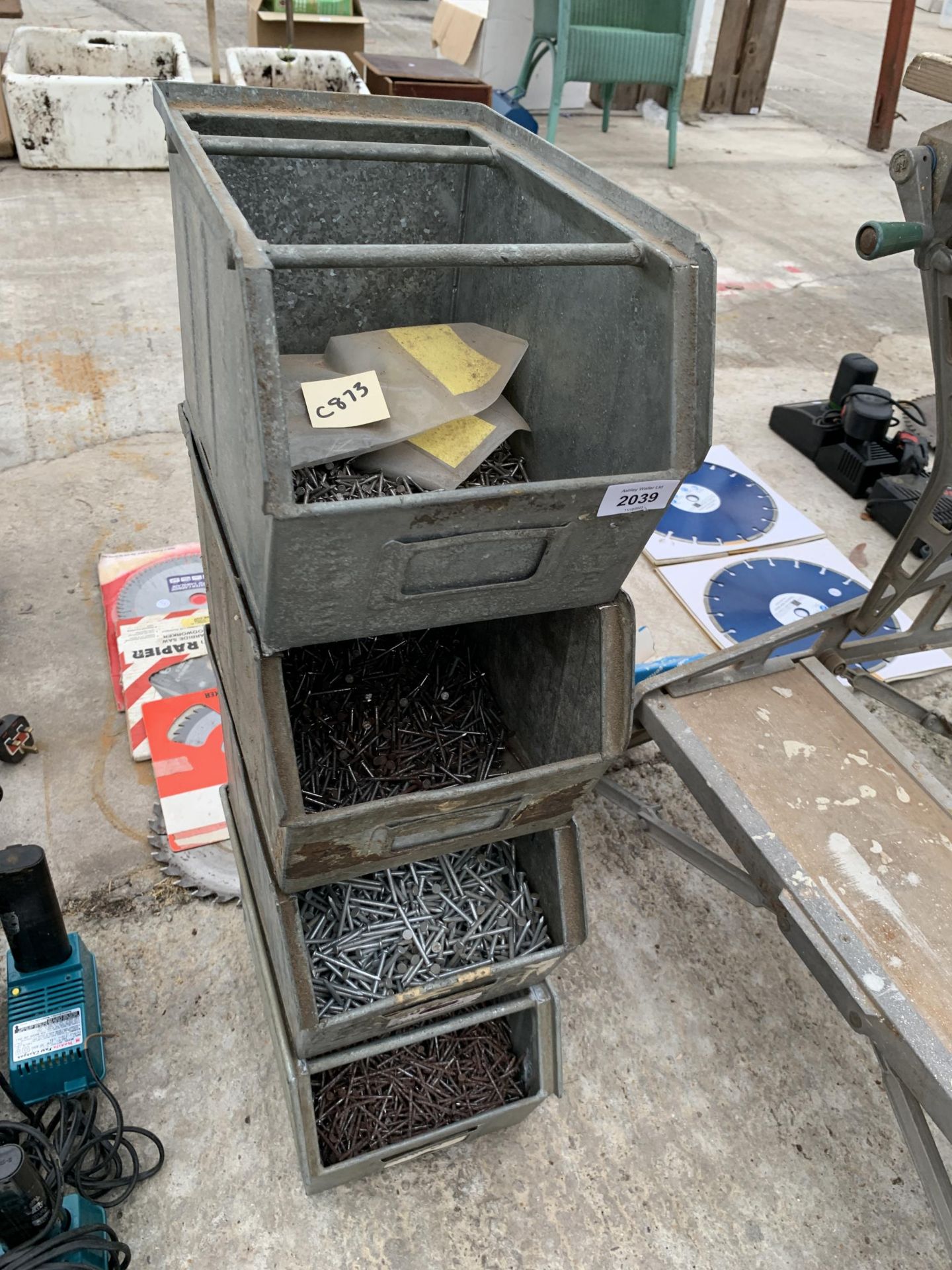 FOUR GALVANISED STORAGE BINS CONTAINING A LARGE QUANTITY OF NAILS