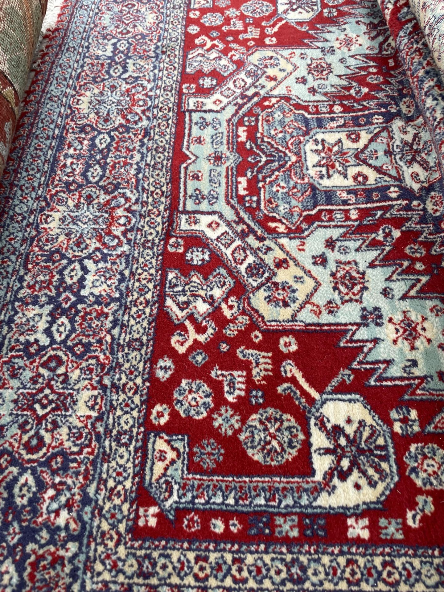 A RED PATTERNED FRINGED RUG - Image 2 of 2