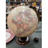 AN ILLUMINATED WORLD GLOBE ON A WOODEN STAND, HEIGHT APPROX 38CM