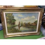 A LARGE GILT FRAMED OIL ON CANVAS OF A BOAT ON A STREAM FLANKED BY COTTAGES AND TREES, INDISTINCT
