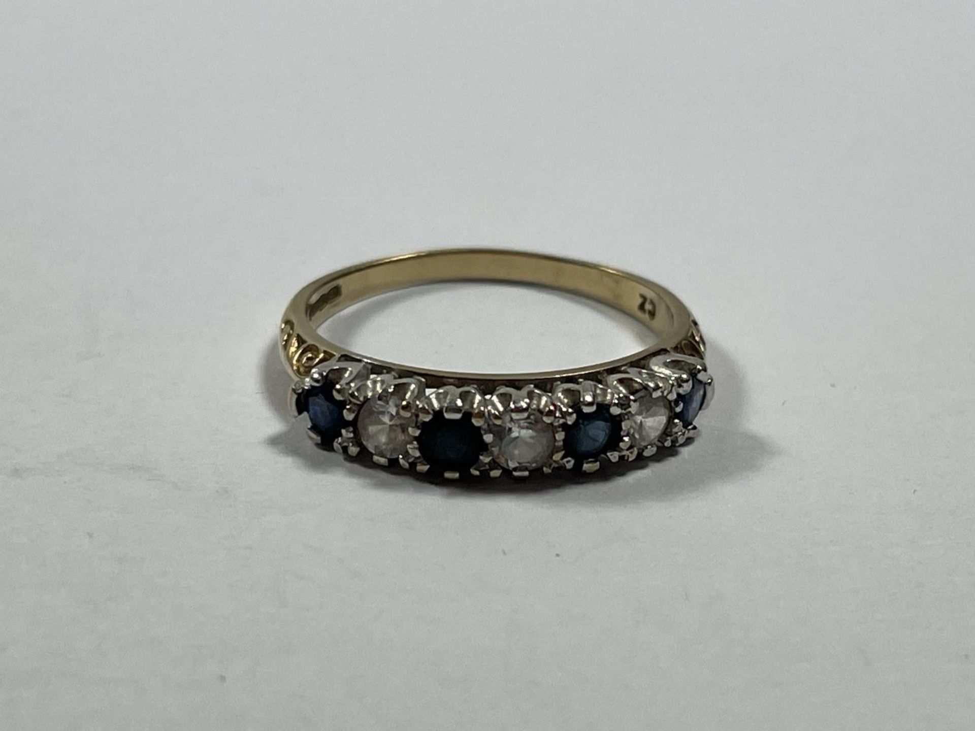 A 9 CARAT GOLD RING WITH FOUR SAPPHIRES AND THREE CUBIC ZIRCONIAS IN A LINE SIZE M - Image 3 of 3