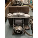 A VINTAGE VELIO BELLOWS CAMERA WITH LEATHER CASE