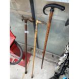 THREE DECORATIVE VINTAGE WALKING STICKS TO INCLUDE ONE WITH A FISH HANDLE AND ONE WITH A POSSIBLE