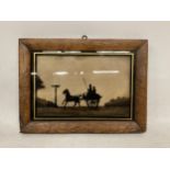 A FRAMED SILHOUETTE GLASS SLIDE TITLED 'OFF TO THE DERBY'