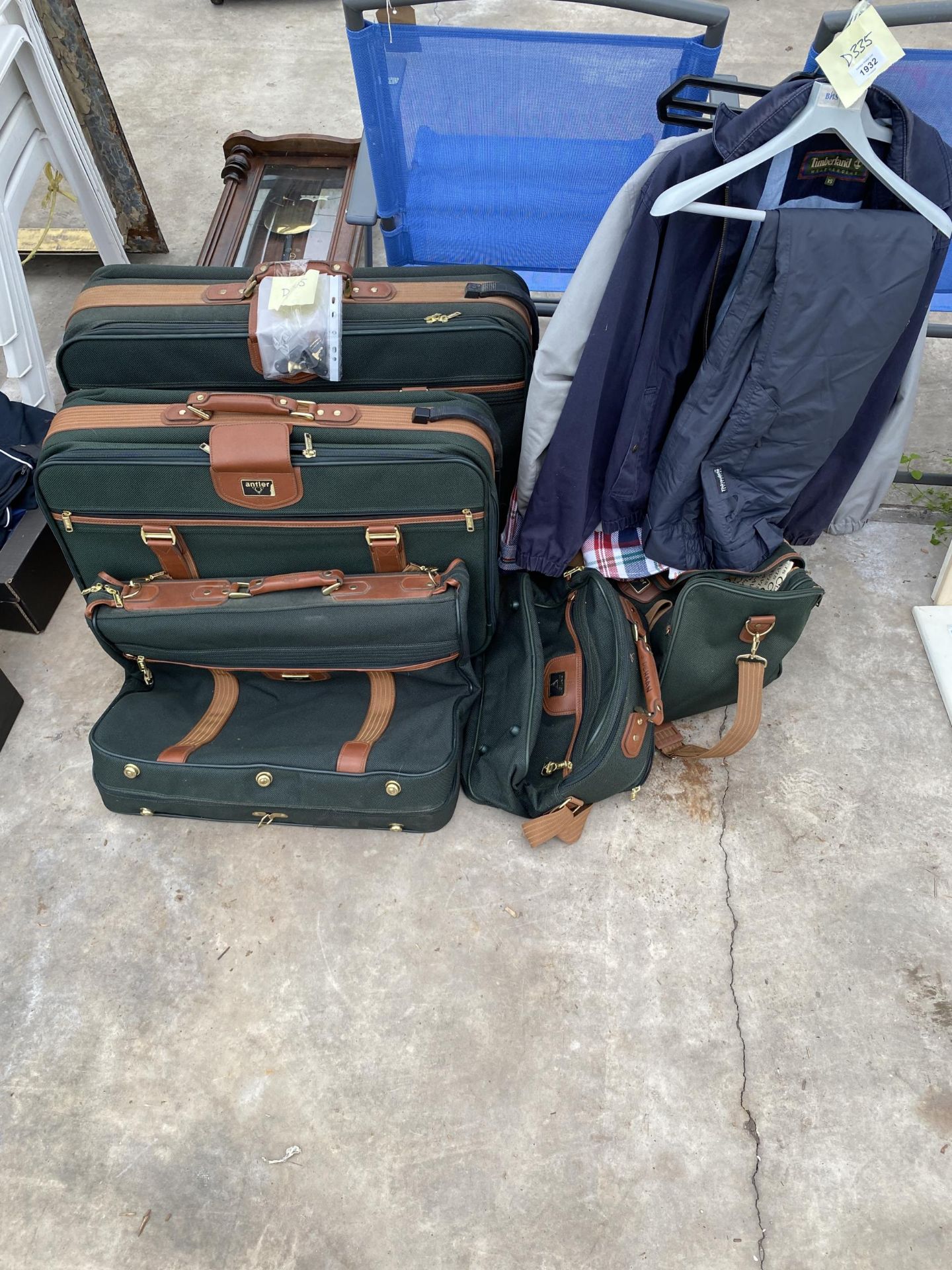 A SET OF FIVE GRADUATED ANTLER TRAVEL CASES AND SOME GENTS CLOTHES