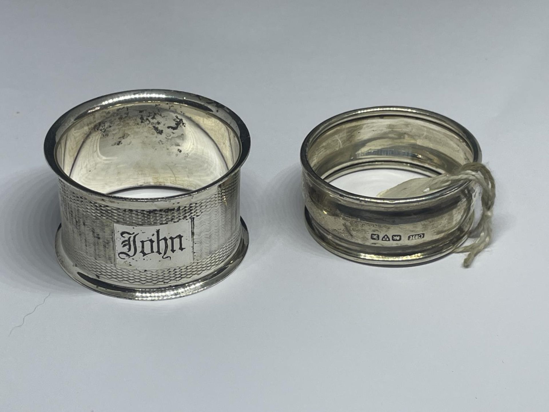 TWO NAPKIN RINGS TO INCLUDE A CHESTER HALLMARKED AND A SILVER PLATED
