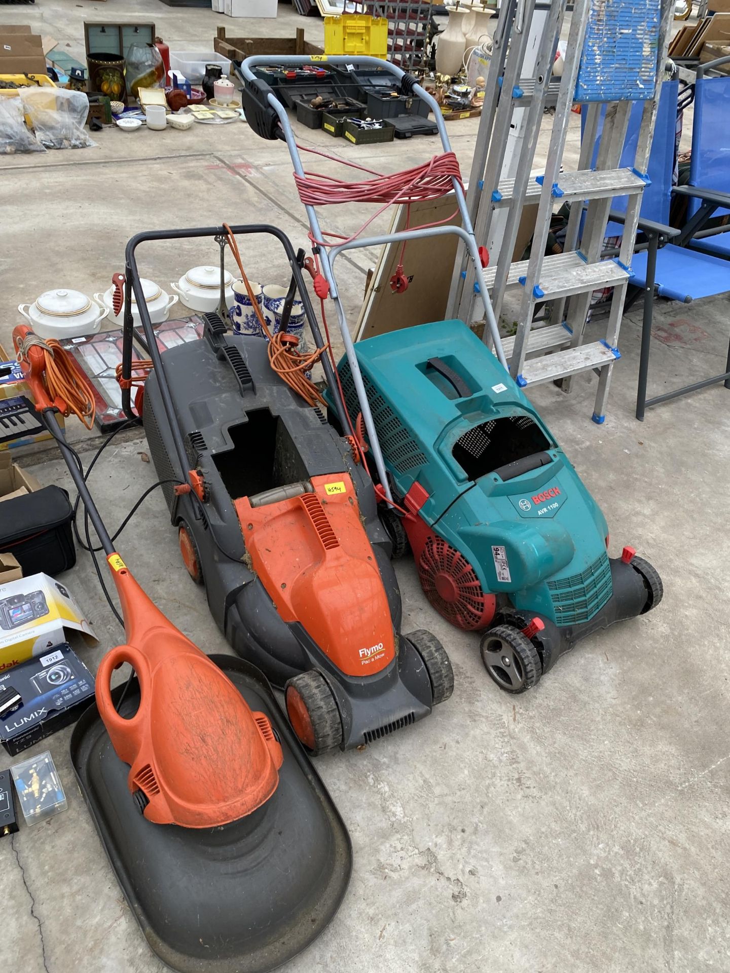 TWO ELECTRIC LAWN MOWERS AND A SCARIFIER TO INCLUDE A BOSCH AVR 1100 AND A FLYMO ETC