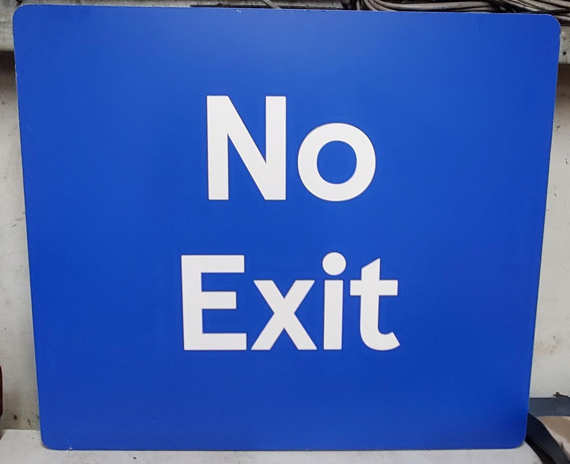 A LARGE BLUE 'NO EXIT' SQUARE SIGN