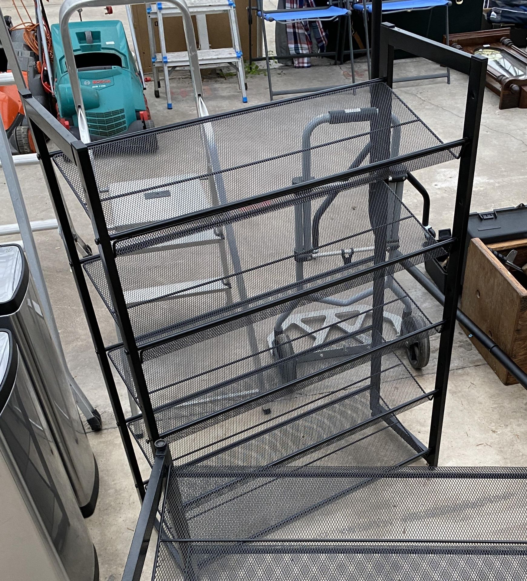 A FIVE TIER METAL AND MESH SHOE RACK