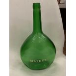 A VINTAGE GREEN GLASS MATEUS WINE DECANTER